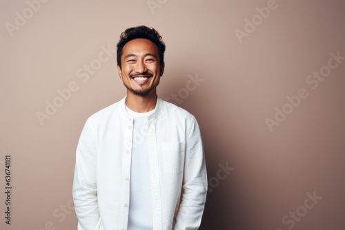 Portrait of a handsome asian man laughing and looking at camera