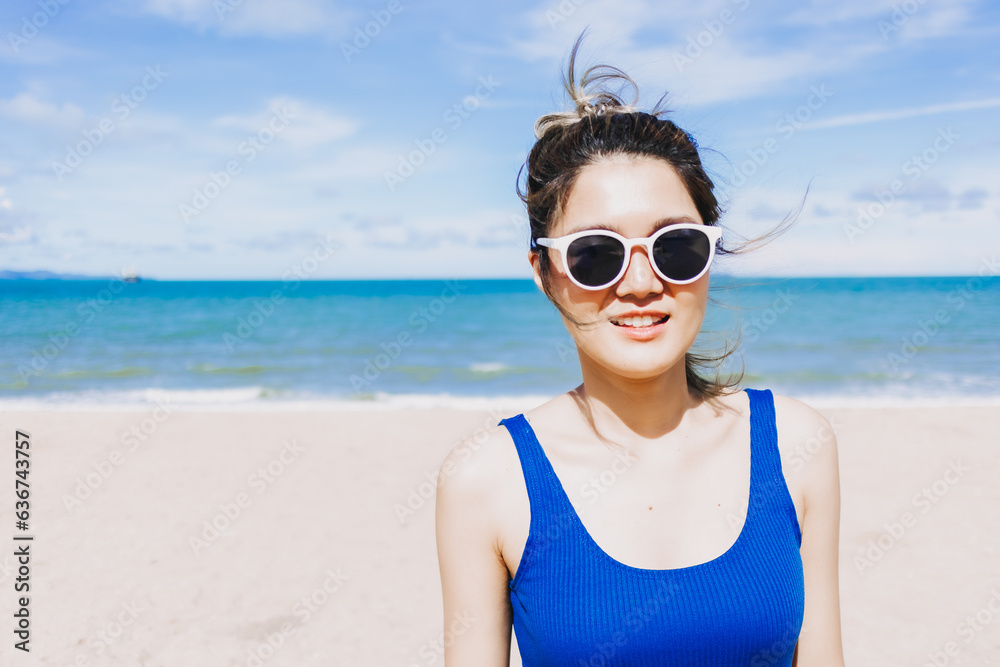 Happy asian woman on the sunny beach with sun glasses. Concept of sun protection Happy asian woman on the sunny beach with sun glasses. Concept of sun protection