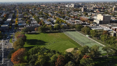Aerial view of football field near houses in old Montreal district, Canada at autumn. View of Mont Royal mountain park.  Drone footage  on sunset.