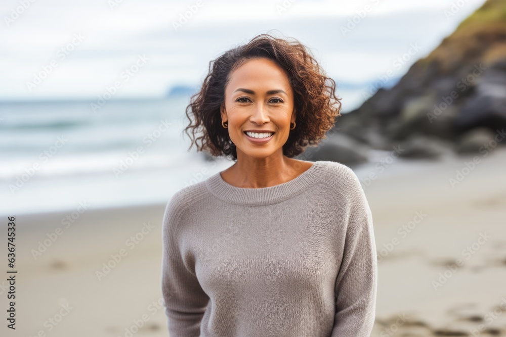 Portrait of smiling woman standing on the beach at the day time Portrait of smiling woman standing on the beach at the day time