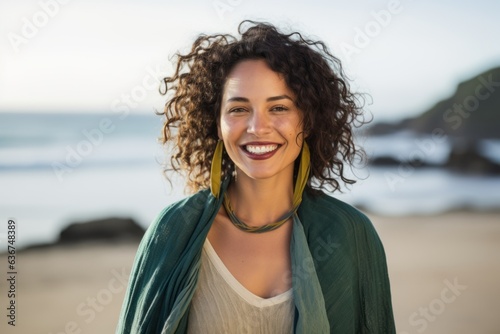 Portrait of smiling woman with scarf on the beach at the day time