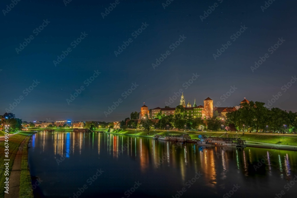 Wawel Royal Castle surrounded by a lake in the evneing in Krakow, Poland