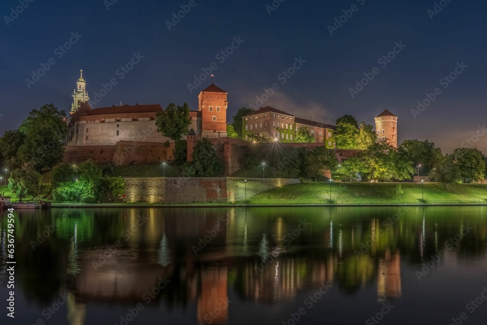 Wawel Royal Castle surrounded by a lake in the evneing in Krakow, Poland