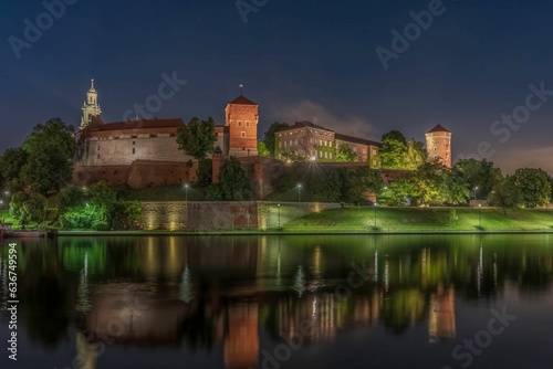Wawel Royal Castle surrounded by a lake in the evneing in Krakow, Poland © Roger28/Wirestock Creators