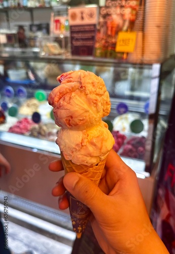 hand holding ice cream at ice cream shop