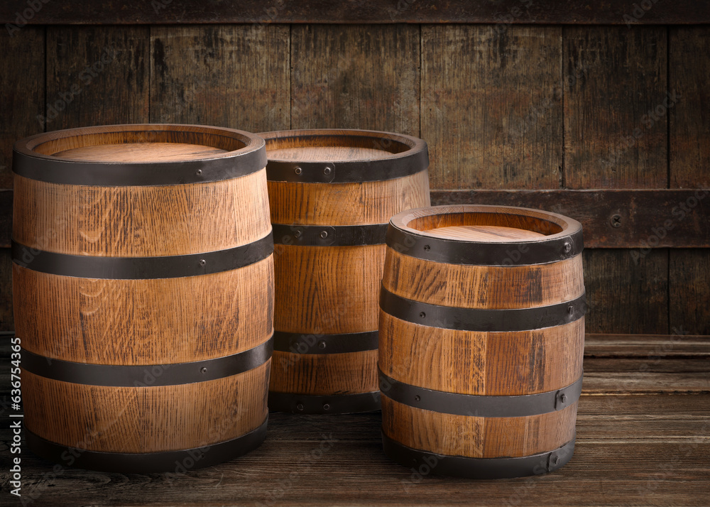 Three wooden barrels of different sizes in cellar