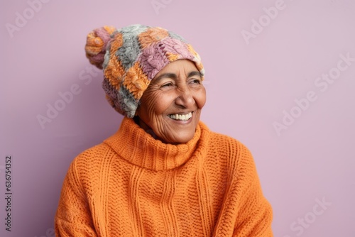 Medium shot portrait of a Saudi Arabian woman in her 90s in an abstract background wearing a cozy sweater
