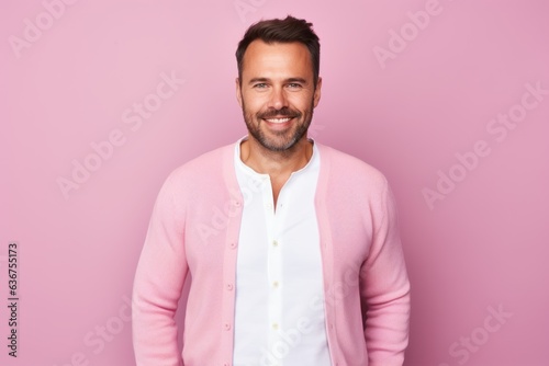 Portrait of a Russian man in his 30s in a pastel or soft colors background wearing a chic cardigan