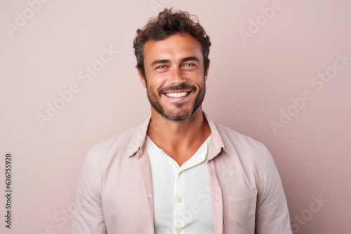 Portrait of a Brazilian man in his 30s in a pastel or soft colors background wearing a chic cardigan