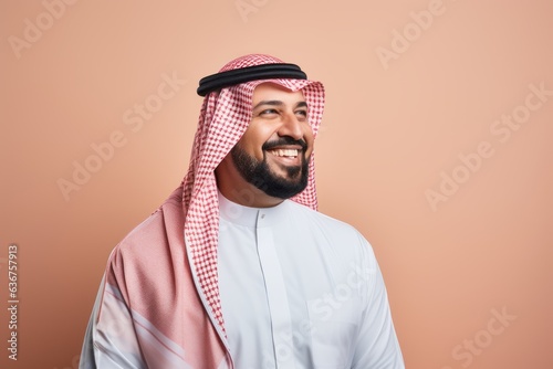 Portrait of a Saudi Arabian man in his 40s in a pastel or soft colors background wearing a foulard