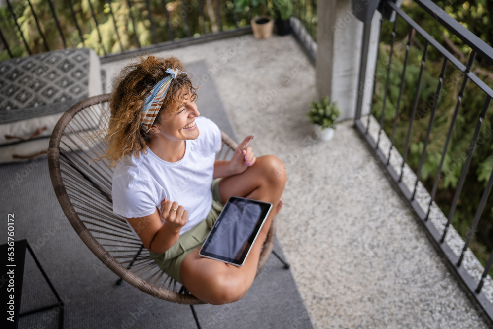 One woman shopping online hold credit card and digital tablet One woman shopping online hold credit card and digital tablet
