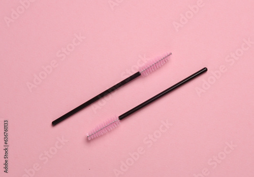 Brushes for combing eyelashes on pink background. Beauty concept