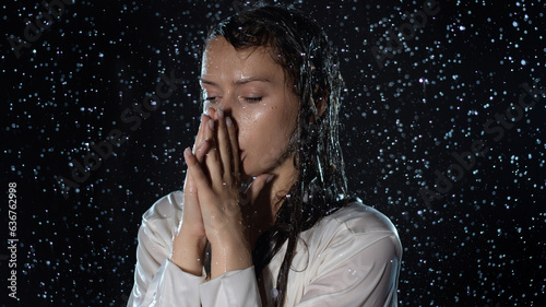 Billede på lærred young woman in the rain, getting wet through, wet clothes and water running down her face