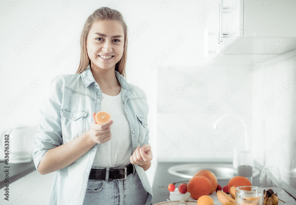 Cheerful hipster woman having fun with a lemon in her hands in a modern kitchen. Healthy food. Fruits, vitamins and antioxidant Cheerful hipster woman having fun with a lemon in her hands in a modern kitchen. Healthy food. Fruits, vitamins and antioxidant