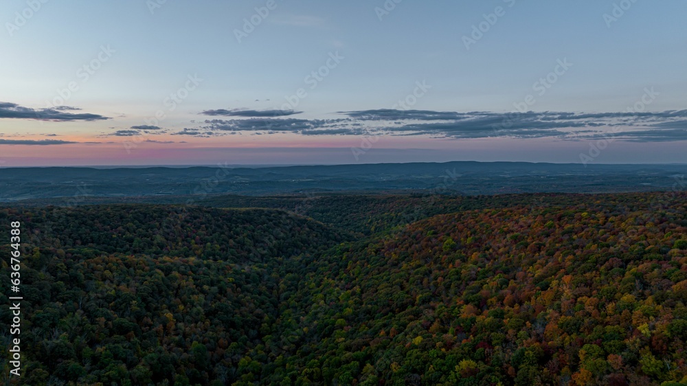 Beautiful scene of an autumn landscape during sunset with colorful trees