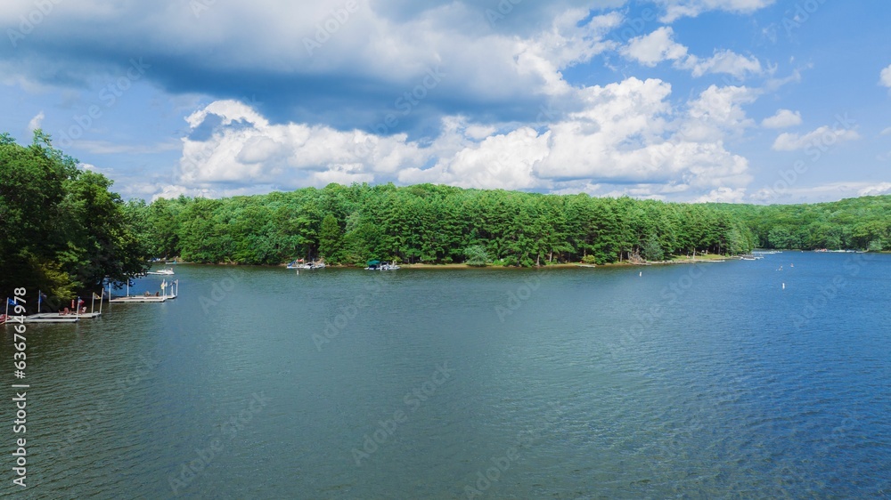 Fototapeta premium a wide blue lake with people on it in the middle