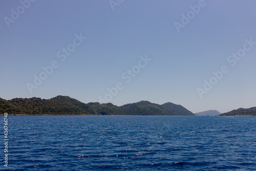 Beautiful seascape on a sunny day In Turkey. The Mediterranean Sea  surrounded by mountains  with picturesque islands on a summer day. Summer background with blue ocean