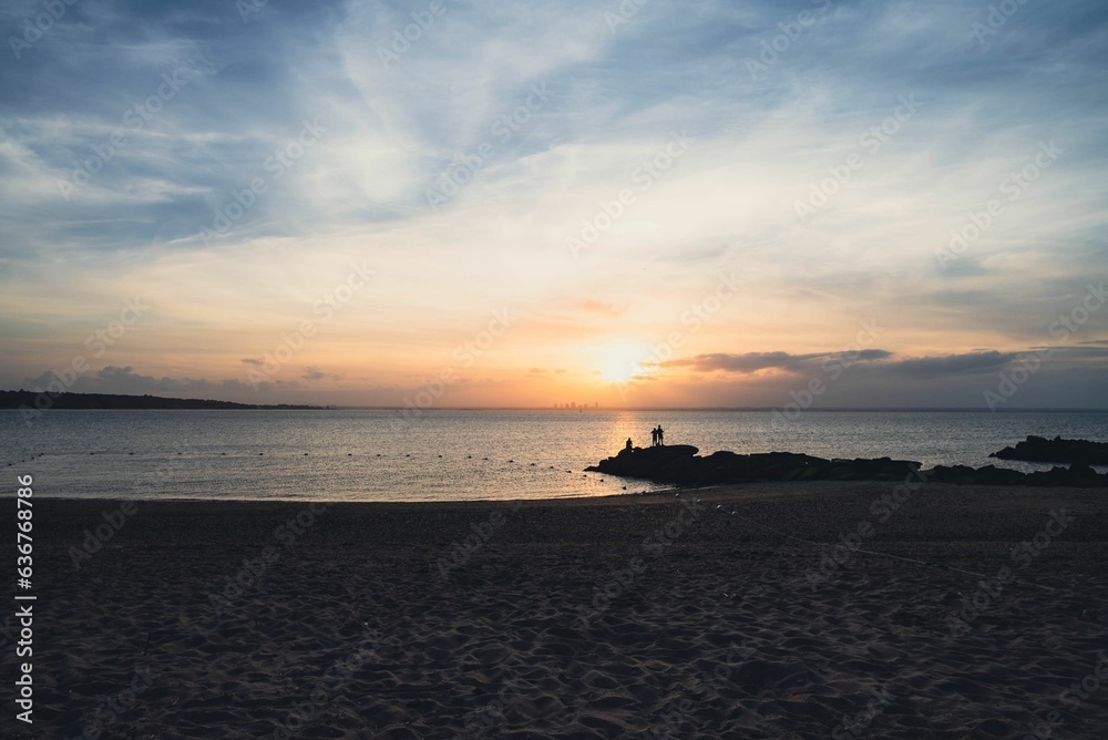 Beautiful shot of silhouettes on Long Island beach at sunset