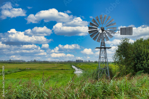 A water mill, used to regulate water levels in low-lying areas, in the low moorland swamp of National Park De Alde Feanen in the province of Friesland, the Netherlands
