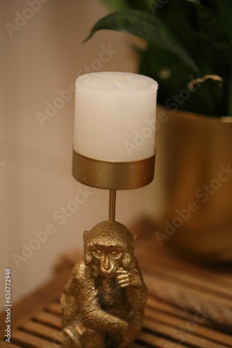 Closeup of a decorative golden monkey candle holder. photo