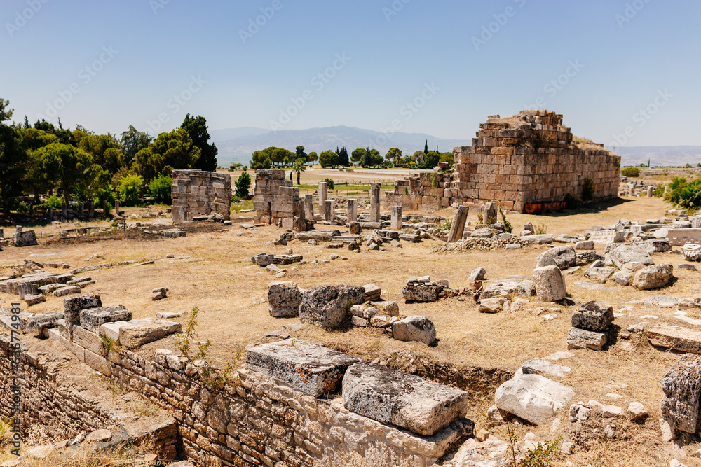 Old dilapidated architecture of Turkey. Ruins of an ancient city. Journey to the old city. Mountain landscape. Ancient city of Hierapolis, Pamukkale, Türkiye - July 29, 2023