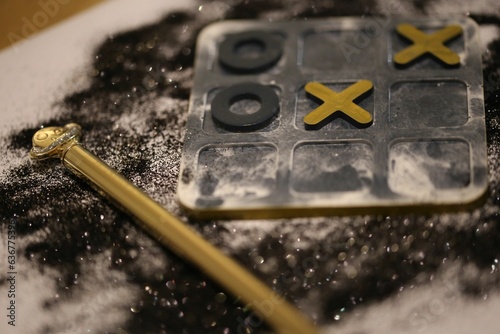 Close-up of a board game with tic tac toe game pieces