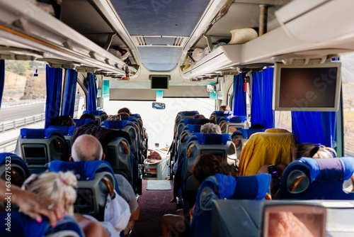 Many people travel in a comfortable large bus on a summer day. Ancient city of Pamukkale, Hierapolis, Türkiye - July 29, 2023 photo