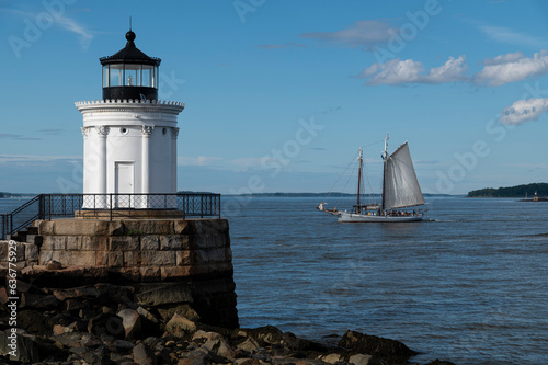 Schooner Sailboat with Two Masts Passes by Portland Breakwater Lighthouse in Maine