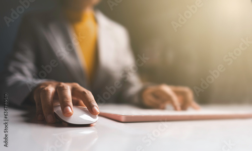 Business woman hands using Laptop typing on keyboard and surfing the internet on office table.