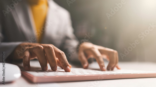 Business woman hands using Laptop typing on keyboard and surfing the internet on office table.