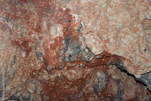 Close-up shot of an array of rock formations featuring streaks of bright red and white paint