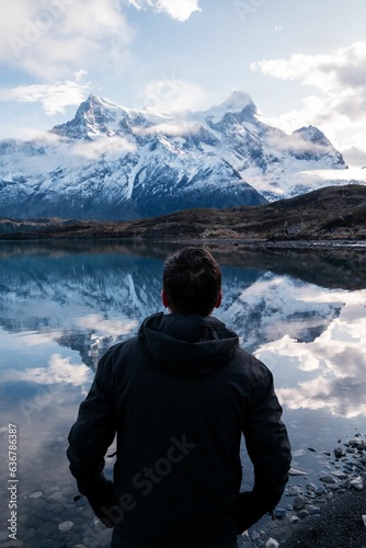 Adult hiker looking at rocky snowy mountains in Torres del Paine National Park, Chile © Daniel Andrés Clavería Zapata/Wirestock Creators