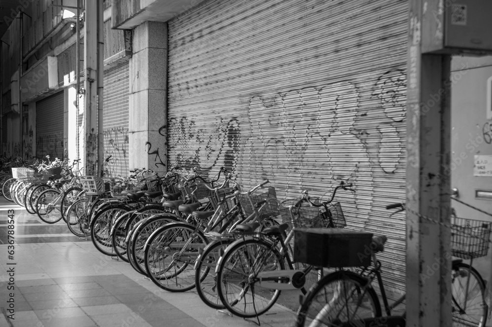 Black and white photos of many bicycles