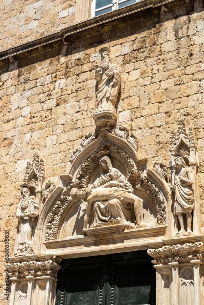 A fragment of the decoration above the entrance to the Franciscan Church of the Little Brothers in the Old Town of Dubrovnik, Croatia