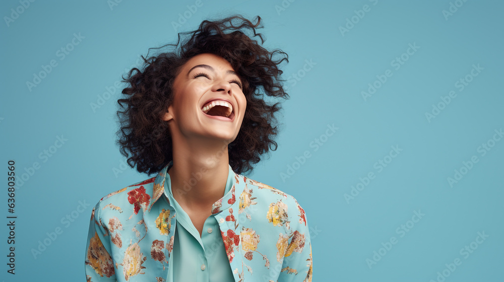 Beautiful woman laughing against a Blue Background with Copy Space Beautiful woman laughing against a Blue Background with Copy Space