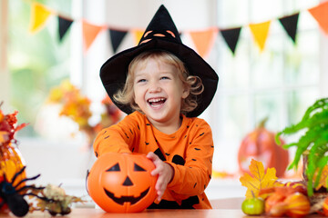 Child in Halloween costume. Kids trick or treat.