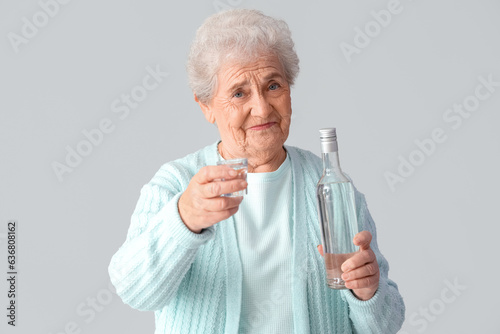 Senior woman with glass and...