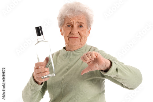 Senior woman with bottle of...