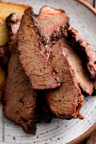 Sliced smoked brisket on a plate with toast photo