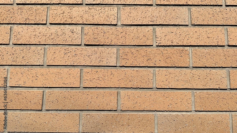 Fototapeta premium Brown brick wall taken from a straight line