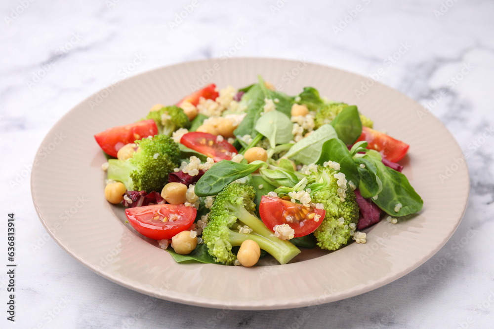 Healthy meal. Tasty salad with quinoa, chickpeas and vegetables on white marble table, closeup Healthy meal. Tasty salad with quinoa, chickpeas and vegetables on white marble table, closeup