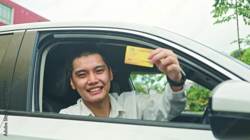 Portrait handsome asian gentleman driving car showing his member insurance card for customer peace of mind in using the car and driving safely with insurance policy.
Portrait handsome asian gentleman driving car showing his member insurance card for customer peace of mind in using the car and driving safely with insurance policy.