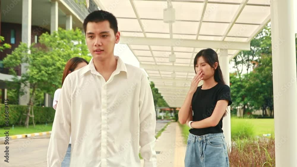 Man smoking cigarette that emits stinky fumes on the sidewalk, irritating teenage girls with disgusting behavior : Campaign refrains from smoking concept.