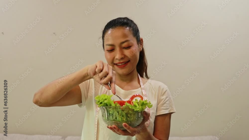 Young asian woman showing off eating nutritious bell peppers and fresh vegetables for a healthy and fat-free lunch : Health care, reduce fat diet and weight loss. Young asian woman showing off eating nutritious bell peppers and fresh vegetables for a healthy and fat-free lunch : Health care, reduce fat diet and weight loss.