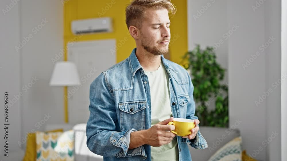 Young caucasian man drinking coffee standing at home Young caucasian man drinking coffee standing at home