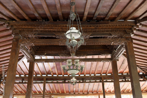 ancient Javanese hanging lamps on building roofs and carved ceilings typical of ancient Indonesian Javanese