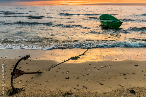 Coastal landscape with fishing boat anchored on sandy beach of the Baltic Sea