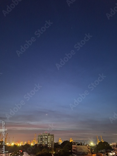 Captivating twilight sky over a serene harbour with a mesmerizing gradient. The Crescent moon adds intrigue to the scenic view. Perfect for any project  