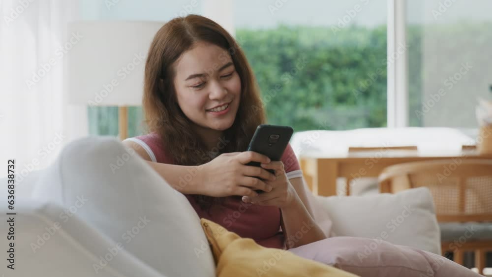 Asia people young female Gen Z using cellphone enjoy fun chatbot typing text AI chat app sitting easy at sofa home. Latin teen girl happy relax looking reading gossip news on cyber buying paying money Asia people young female Gen Z using cellphone enjoy fun chatbot typing text AI chat app sitting easy at sofa home. Latin teen girl happy relax looking reading gossip news on cyber buying paying money
