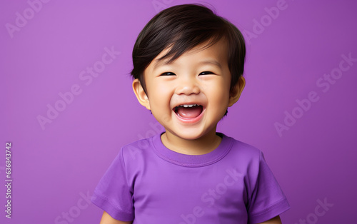 Fototapeta Portrait of happy asian baby in color clothing on color background